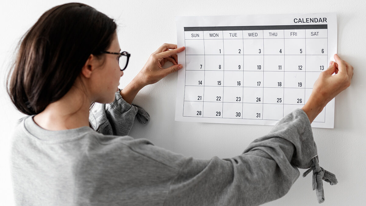 mulher pendurando calendário